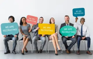 Team of businesspeople holding colorful signs